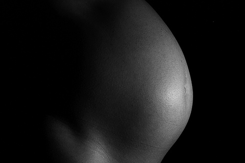 Black African American woman pregnant belly faceless mothering